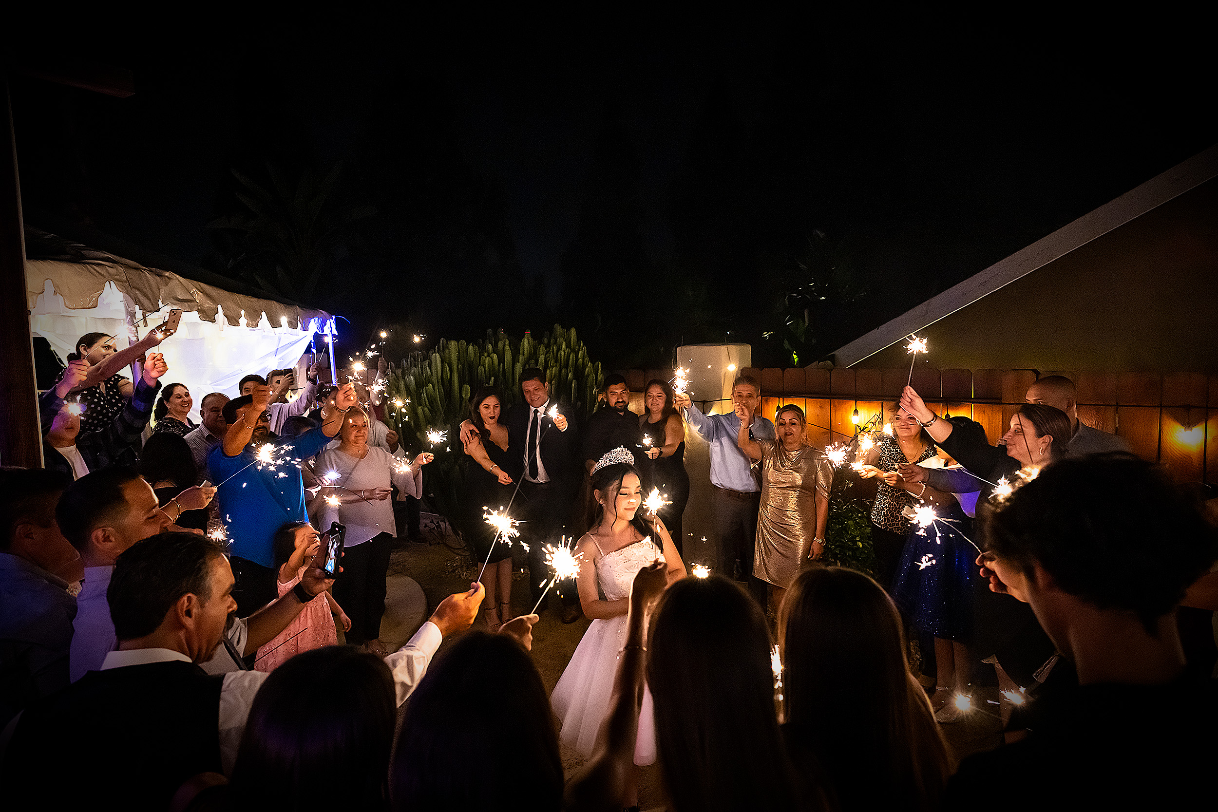 A celebration surrounded by family and friends holding sparklers