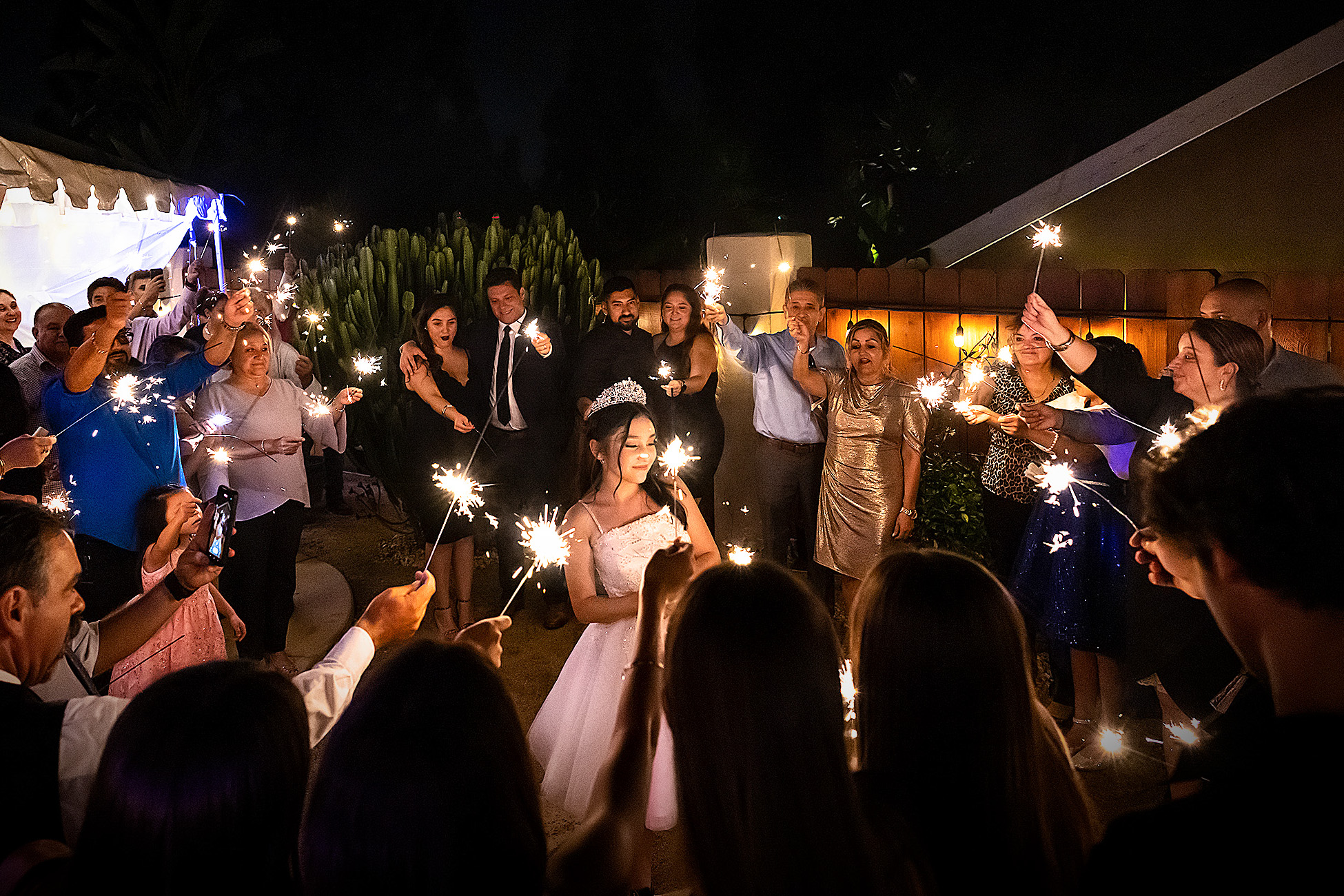 A celebration surrounded by family and friends holding sparklers